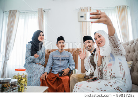 two Muslim couples selfie while celebrating Eid Al-Fitr 99817282