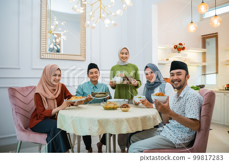 happy family look at camera together in the dining room 99817283