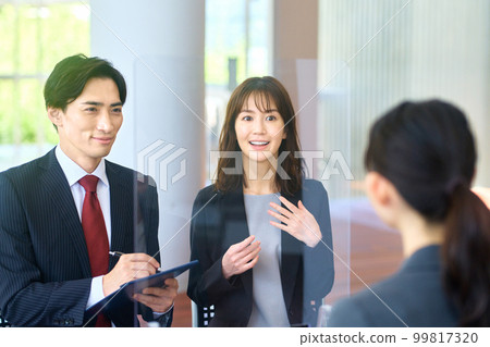 Male and female business people interviewing at a venue with measures against infectious diseases 99817320