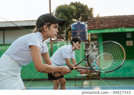 mixed doubles female tennis player ready to receive the ball 99817343