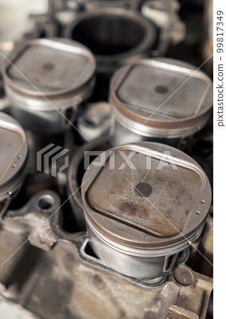Many tools and auto spare parts car at a car repair shop. Car parts for repairs. Used vehicle part for recycling in the scrap yard garage. Many tools and auto spare parts car at a car repair shop. Car parts for repairs. Used vehicle part for recycling in the scrap yard garage. 99817349
