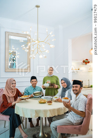 happy family look at camera together in the dining room 99817479