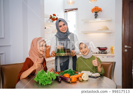 muslim woman serving drink for friend and family after fasting muslim woman serving drink for friend and family after fasting 99817513