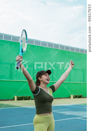 female tennis player in hand gesture symbol of victory 99817653