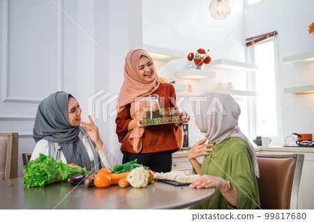 muslim woman serving drink for friend and family after fasting muslim woman serving drink for friend and family after fasting 99817680