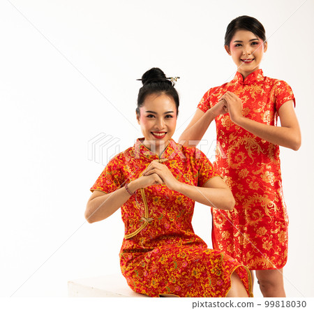 two beautiful asian woman in cheongsam greetings for lunar new year two beautiful asian woman in cheongsam greetings for lunar new year 99818030