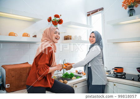 muslim woman friend preparing some food for dinner muslim woman friend preparing some food for dinner 99818057