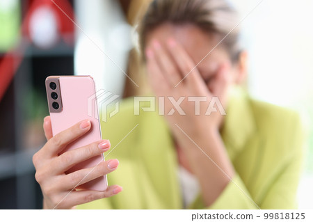 Female hand holding modern smartphone in hand Female hand holding modern smartphone in hand 99818125
