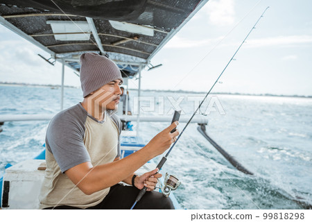 fisherman takes a cell phone photo of the situation around fisherman takes a cell phone photo of the situation around 99818298