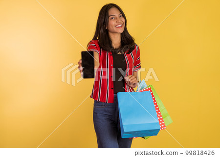 asian woman standing and showing the phone while holding asian woman standing and showing the phone while holding 99818426