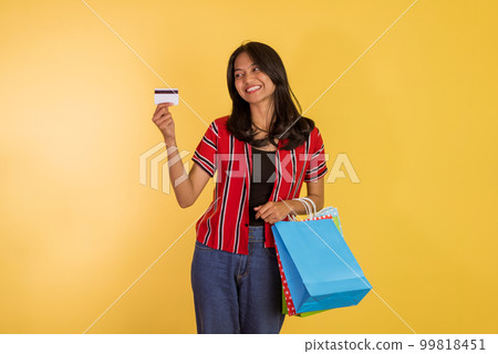 asian woman showing the blank card while holding the shopping bags 99818451