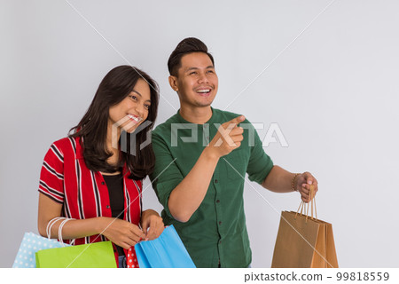 the asian guy pointing with his finger and smiling the asian guy pointing with his finger and smiling 99818559