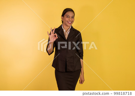 asian woman in formal outfit standing with oke hand gesture 99818718