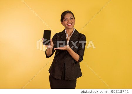 asian woman in formal outfit standing with smile and showing the phone 99818741