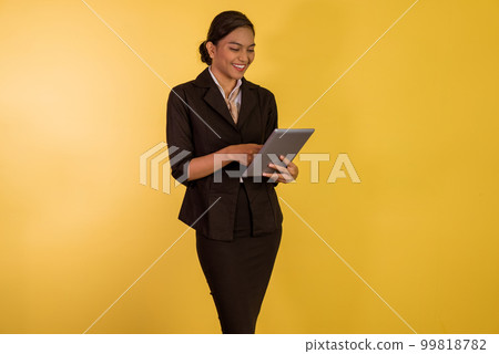 asian woman in formal outfit using the digital tablet at her hand 99818782
