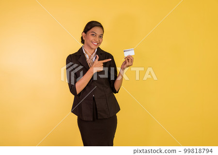 woman in formal outfit standing with pointed finger on the blank card 99818794