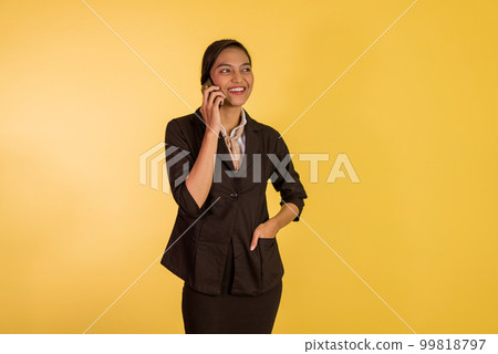 asian woman in formal outfit calling someone on phone 99818797