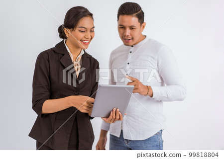asian man pointed his finger while looking at the digital tablet 99818804