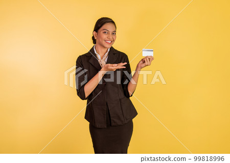 asian woman in formal outfit showing and pointing on the blank card 99818996