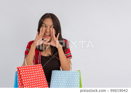 a beautiful asian girl shouting and open her hands in front of her mouth 99819042