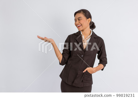 woman in formal outfit pointing on the empty space at her side 99819231