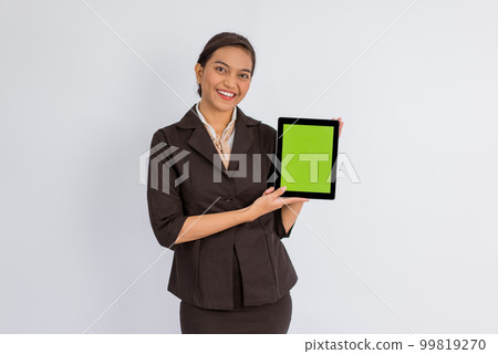 beautiful woman in formal outfit showing the digital tablet with green screen 99819270