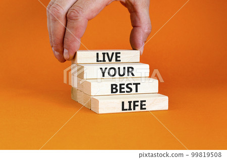 Live your best life symbol. Concept words Live your best life on wooden blocks. Beautiful orange table orange background. Businessman hand. Business live your best life concept. Copy space. 99819508