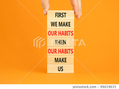 Our habits symbol. Concept words First we make our habits then our habits make us on wooden blocks. Beautiful orange background. Copy space. Businessman hand. Motivational business our habits concept. Our habits symbol. Concept words First we make our habits then our habits make us on wooden blocks. Beautiful orange background. Copy space. Businessman hand. Motivational business our habits concept. 99819633