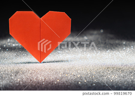 Paper heart, color of the year 2023 Viva Magenta , origami on a black background with white sequins Paper heart, color of the year 2023 Viva Magenta , origami on a black background with white sequins 99819670