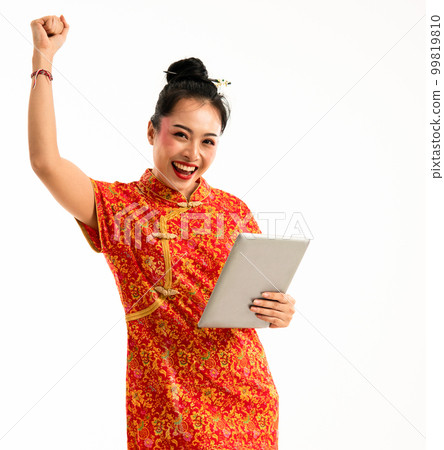 beautiful woman in cheongsam standing with tablet at her left hand 99819810