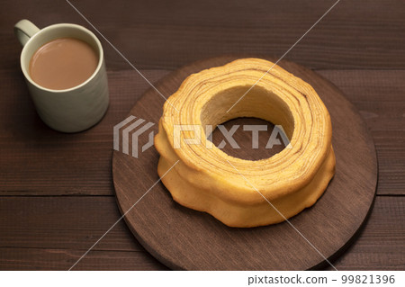 Top view of baumkuchen, sakotis ,sekacz on brown wooden table, delicious homemade traditional spit cake with a cup of coffee. Horizontal plane, flatly Top view of baumkuchen, sakotis ,sekacz on brown wooden table, delicious homemade traditional spit cake with a cup of coffee. Horizontal plane, flatly 99821396