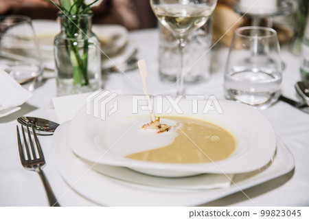 Creamy pumpkin soup with cream sauce and grilled shrimp, restaurant concept, celebration Creamy pumpkin soup with cream sauce and grilled shrimp, restaurant concept, celebration 99823045