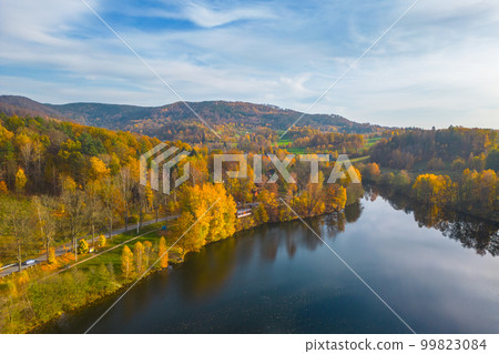 Fojtka water reservoir surrounded by vibrant colored forest at autumn time. Aerial view from drone. 99823084