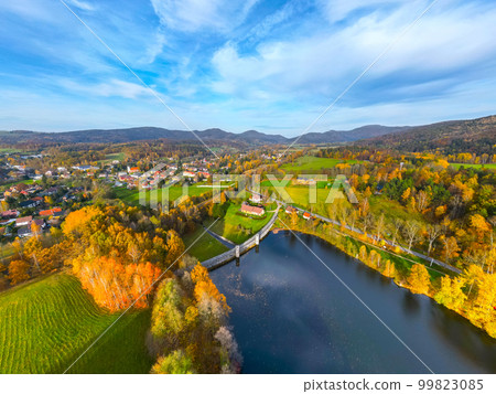 Fojtka water reservoir surrounded by vibrant colored forest at autumn time. Aerial view from drone. 99823085