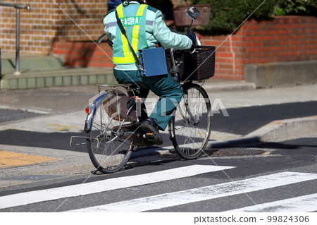 Parking warden moving by bicycle 99824306