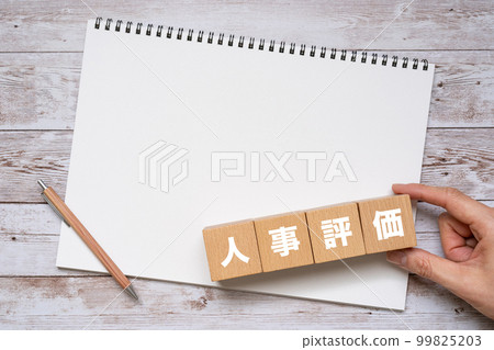 Personnel evaluation written block, notebook, pen and hand Personnel evaluation written block, notebook, pen and hand 99825203