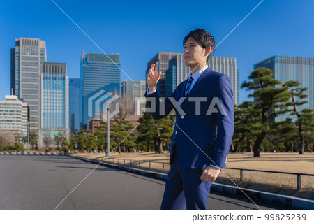 Young businessman in drinking pose 99825239