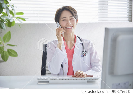 Female doctor doing online medical treatment on a smartphone 99825698