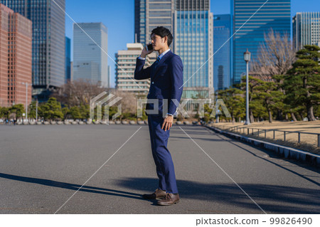businessman talking on smartphone businessman talking on smartphone 99826490