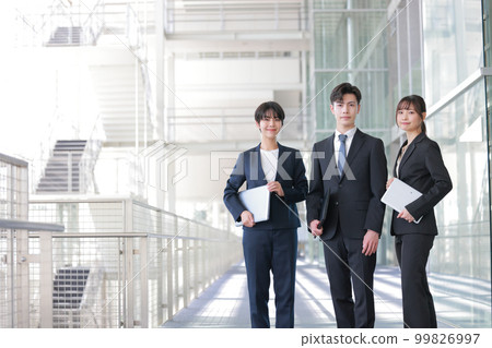 Three business people holding devices_2 99826997
