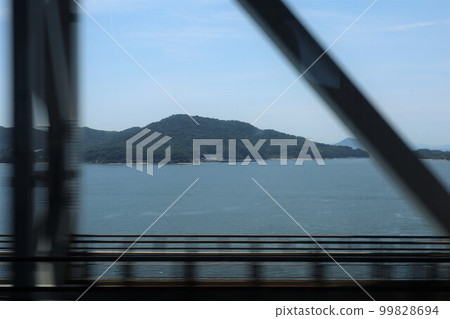 Traveling from Okayama to Takamatsu by JR through the Seto Ohashi Bridge and crossing the Seto Inland Sea in July 99828694