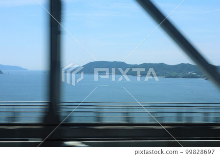 Traveling from Okayama to Takamatsu by JR through the Seto Ohashi Bridge and crossing the Seto Inland Sea in July 99828697