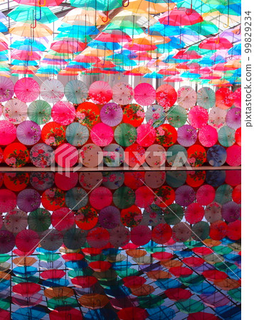 Colorful umbrellas and water surface Colorful umbrellas and water surface 99829234