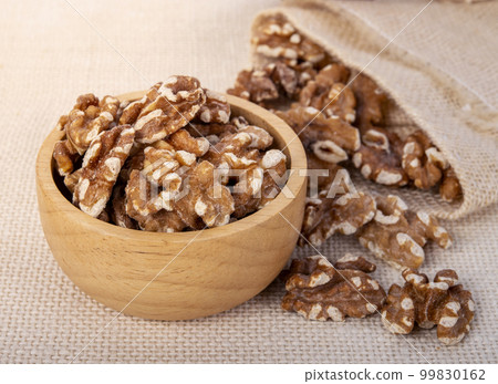 Walnut kernels in a wooden bowl 99830162