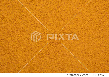 Poured turmeric powder spice background. Dry seasoning turmeric. Spices and herbs for cooking, curcuma Poured turmeric powder spice background. Dry seasoning turmeric. Spices and herbs for cooking, curcuma 99837879