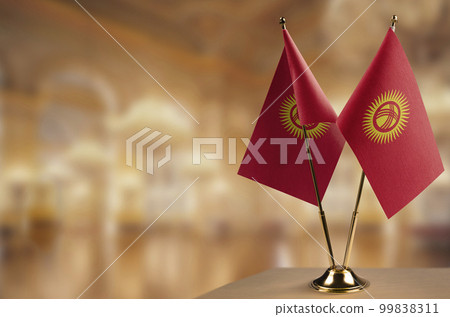 Small flags of the Kirghizia on an abstract blurry background 99838311