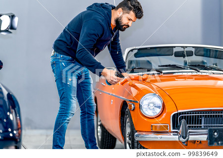Professional detailing, polish, wash and cleaning car with microfiber in garage Professional detailing, polish, wash and cleaning car with microfiber in garage 99839649