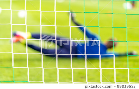 Blurred view soccer goalkeeper in the goal 99839652