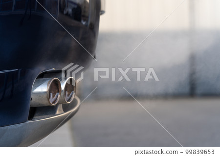 smoke from the exhaust of a car with a gasoline engine smoke from the exhaust of a car with a gasoline engine 99839653