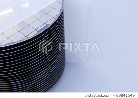 Silicon wafer inspection. A batch of silicon wafers packed in a plastic storage box in the clean room of a semiconductor foundry ready for microchip production. Silicon wafer inspection. A batch of silicon wafers packed in a plastic storage box in the clean room of a semiconductor foundry ready for microchip production. 99841549